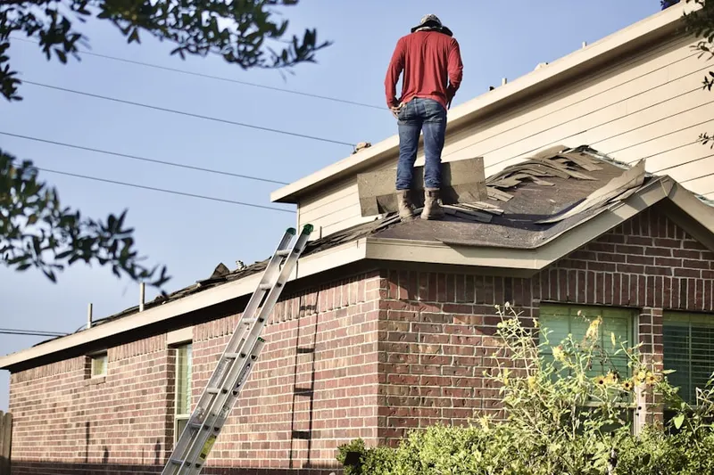 Professional roofer working on a residential roof in Seaview